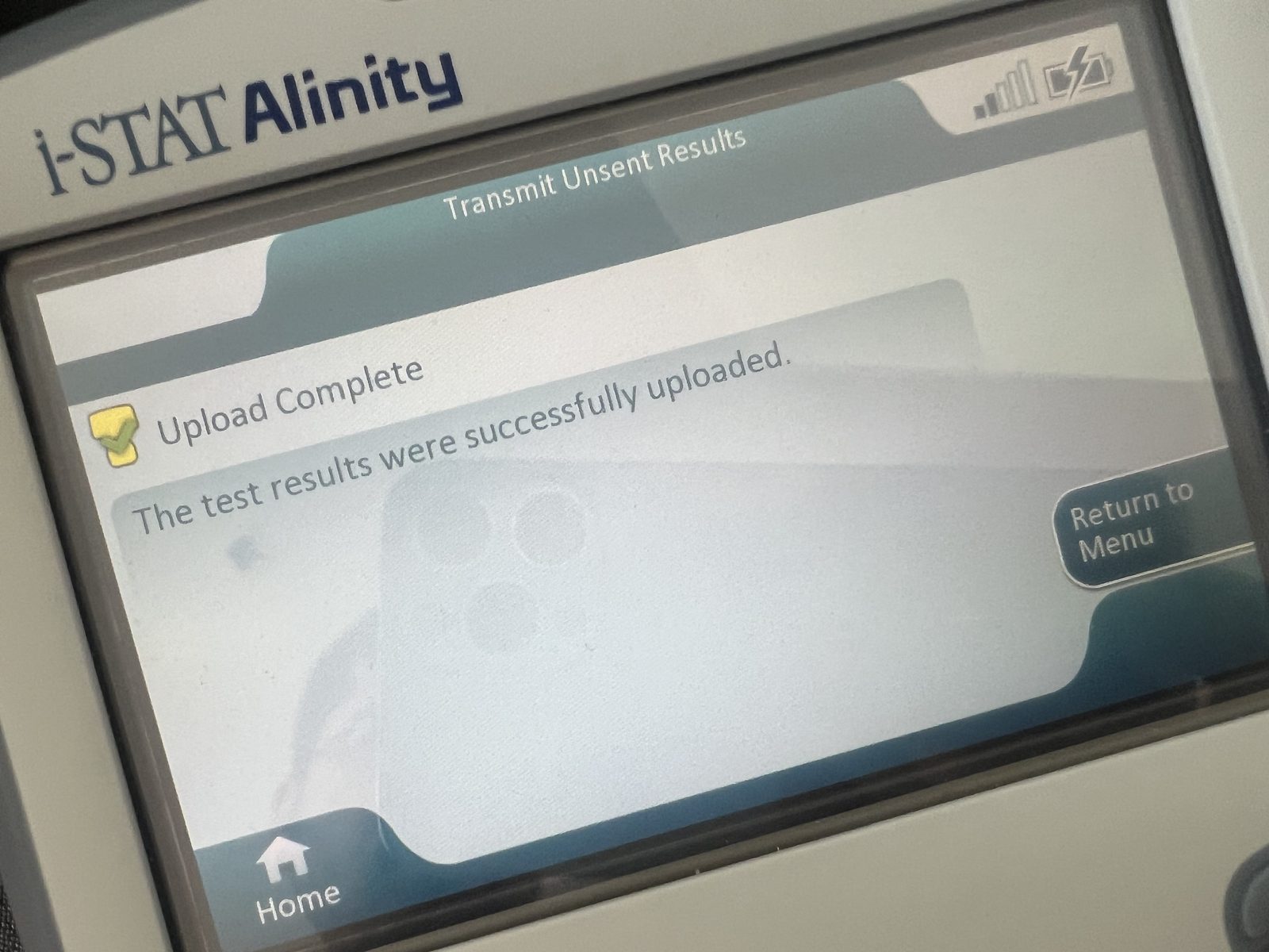 Transmit Unsent Results screen showing Upload Complete, results sent to laboratory software